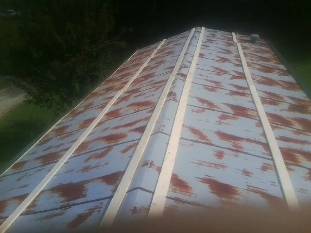 Rusted metal roof panels with new wood purlins before replacement — Storm Damage Roof Repair in Kittery Point by Roofing Brothers